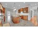 Large eat-in kitchen offers a tile floor, granite countertops, and a spacious center island with barstool seating at 1012 S Addison Way, Aurora, CO 80018
