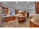 Expansive kitchen with granite counters, stainless appliances, tile floors and center island with seating at 1012 S Addison Way, Aurora, CO 80018