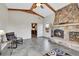 Cozy living room features a stone fireplace with a wood-burning stove and beamed ceilings at 1012 S Addison Way, Aurora, CO 80018