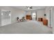 Bright living room with a ceiling fan, neutral walls, wood shelving and comfortable seating near a window at 1012 S Addison Way, Aurora, CO 80018