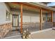 Inviting front porch with stone detailing and space for potted plants at 1012 S Addison Way, Aurora, CO 80018
