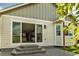 Exterior view of the back of the house with a sliding glass door and a small patio area at 1171 Nathan Pl, Erie, CO 80026