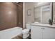 Bathroom with white cabinets, granite countertops, and stylish shower and tub at 1171 Nathan Pl, Erie, CO 80026