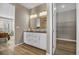 Elegant bathroom with a double vanity, a large mirror, a linen closet, and a separate water closet at 1171 Nathan Pl, Erie, CO 80026