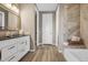 Elegant bathroom with a double vanity, marble shower, and soaking tub for a spa-like experience at 1171 Nathan Pl, Erie, CO 80026