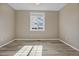 Cozy bedroom featuring wide window and hardwood-style flooring at 1171 Nathan Pl, Erie, CO 80026