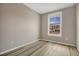 Modest bedroom with a large window and plank flooring at 1171 Nathan Pl, Erie, CO 80026