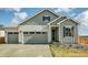 Charming exterior showcasing a two-car garage, well-maintained lawn, and inviting entryway for a welcoming curb appeal at 1171 Nathan Pl, Erie, CO 80026