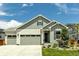 Charming exterior featuring a two-car garage, landscaped yard, and a welcoming front porch at 1171 Nathan Pl, Erie, CO 80026
