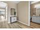 Hallway leads to a bathroom with a vanity and mirror, and a living area with large windows, offering a cozy space at 1171 Nathan Pl, Erie, CO 80026