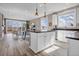 Bright, modern kitchen features white cabinets, a center island, and stainless steel appliances at 1171 Nathan Pl, Erie, CO 80026