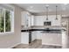 Bright kitchen featuring white cabinets, stainless steel appliances, and modern pendant lighting at 1171 Nathan Pl, Erie, CO 80026