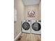 Bright laundry room featuring side-by-side LG washer and dryer appliances at 1171 Nathan Pl, Erie, CO 80026