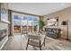Cozy living room featuring a fireplace, comfortable seating, large windows, and a sliding glass door at 1171 Nathan Pl, Erie, CO 80026