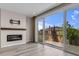 Living room with sliding doors opening to the backyard, fireplace, and modern finishes at 1171 Nathan Pl, Erie, CO 80026