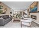 Inviting living area with contemporary furnishings, fireplace, and an open floor plan to the dining and kitchen at 1171 Nathan Pl, Erie, CO 80026