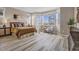 Serene main bedroom with large windows, a queen-size bed, and neutral decor for a relaxing retreat at 1171 Nathan Pl, Erie, CO 80026