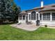 Backyard featuring a spacious patio, dining set, grill and lush green lawn, perfect for outdoor entertaining at 6271 S Billings Way, Centennial, CO 80111
