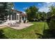 Expansive backyard with lush lawn, mature trees, and a patio area perfect for outdoor entertaining at 6271 S Billings Way, Centennial, CO 80111