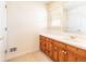 Bathroom features a wooden vanity with a white sink and neutral carpet flooring at 6271 S Billings Way, Centennial, CO 80111