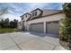 Exterior view of a two-story home with a three-car garage and a well-maintained driveway and landscaping at 6271 S Billings Way, Centennial, CO 80111