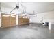 Three-car garage with ample space, featuring paneled doors, overhead lighting, and extra storage capabilities at 6271 S Billings Way, Centennial, CO 80111