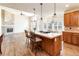 Well-lit eat-in kitchen area featuring a center island with bar seating, wooden cabinetry, and hardwood flooring at 6271 S Billings Way, Centennial, CO 80111
