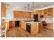 Spacious kitchen with wood cabinets, a center island, and black appliances at 6271 S Billings Way, Centennial, CO 80111