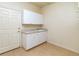Laundry room features a utility sink, white cabinets, and linoleum flooring at 6271 S Billings Way, Centennial, CO 80111