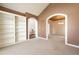 Light and bright living room featuring built-in shelving, carpeted floors and an arched doorway at 6271 S Billings Way, Centennial, CO 80111
