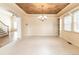 Light-filled formal living room with decorative ceiling and chandelier, built-in shelves, and carpeted floor at 6271 S Billings Way, Centennial, CO 80111