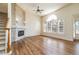 Bright living room with hardwood floors, large window, and stylish fireplace at 6271 S Billings Way, Centennial, CO 80111