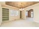 Bright living room with built-in shelving, textured ceiling, carpeted floor and a chandelier light fixture at 6271 S Billings Way, Centennial, CO 80111