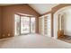 Brightly lit living room with built in shelves, large window, carpeted floor and connecting entryway at 6271 S Billings Way, Centennial, CO 80111