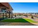 Enjoy this backyard area with synthetic lawn, a view of the playground, and a nearby pool at 3327 Backdrop Ct, Castle Rock, CO 80108