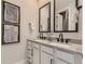 Bathroom features a double vanity with modern fixtures, decorative mirrors, and contemporary design elements at 3327 Backdrop Ct, Castle Rock, CO 80108