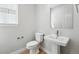 Charming powder room with modern fixtures including a pedestal sink and a modern mirror at 3327 Backdrop Ct, Castle Rock, CO 80108