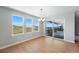 Bright dining area with large windows, a sliding glass door to the patio, and modern chandelier at 3327 Backdrop Ct, Castle Rock, CO 80108