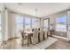 Elegant dining room features hardwood floors, a modern chandelier, and large windows with scenic views at 3327 Backdrop Ct, Castle Rock, CO 80108