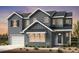 Charming two-story home featuring board and batten siding, a two-car garage and welcoming front porch at 3327 Backdrop Ct, Castle Rock, CO 80108