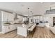 Open kitchen featuring a large island with seating and stainless appliances, and bright white cabinetry at 3327 Backdrop Ct, Castle Rock, CO 80108