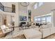 Open-concept living room with a cozy fireplace, soaring ceilings, and lots of natural light at 3327 Backdrop Ct, Castle Rock, CO 80108