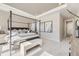 Bright main bedroom featuring a four-poster bed, tray ceiling, and large windows with scenic views at 3327 Backdrop Ct, Castle Rock, CO 80108