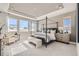 Spacious main bedroom with tray ceiling, large windows with scenic views, and a cozy sitting area at 3327 Backdrop Ct, Castle Rock, CO 80108