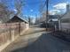 A view down the back alley, showing other garages and utility poles at 410 Baker St, Longmont, CO 80501