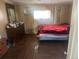 Bedroom with wood paneling and a bed covered with a rose pattern blanket at 410 Baker St, Longmont, CO 80501
