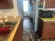 Kitchen area with wood cabinets, appliances and view through to another room at 410 Baker St, Longmont, CO 80501