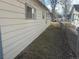 View of side yard, showcasing grass and simple landscaping near the house at 410 Baker St, Longmont, CO 80501
