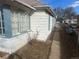 Exterior side view of the house showing the siding and access to backyard at 410 Baker St, Longmont, CO 80501