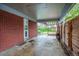 Covered patio with red brick exterior and access to fenced yard at 3200 W Chenango Ave, Englewood, CO 80110
